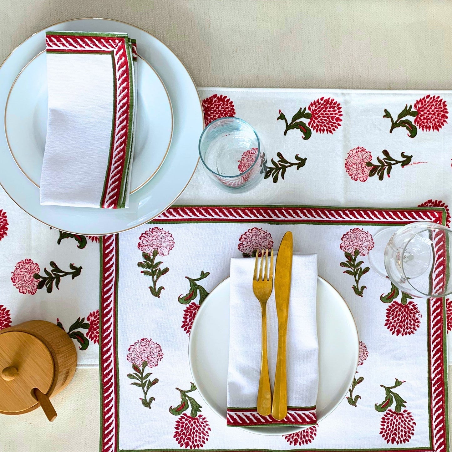 set of 6 napkins with a vibrant red and green block printed border on GOTS certified organic cotton, offering both style and eco-friendliness.