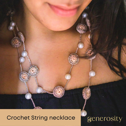 Charming handcrafted necklace combining lightweight design, crochet, and pearls.