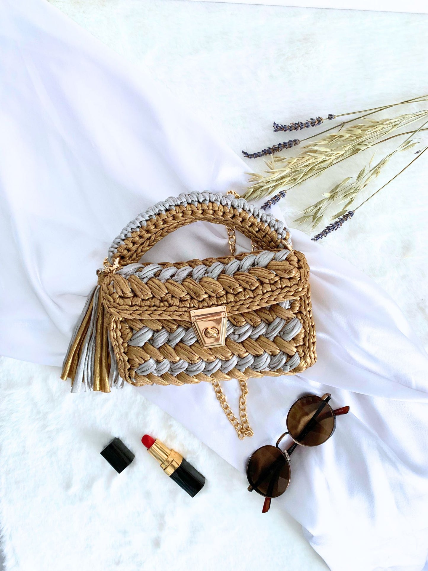 Make a chic statement at parties with our handcrafted crochet bag in a stunning gold and silver combination.