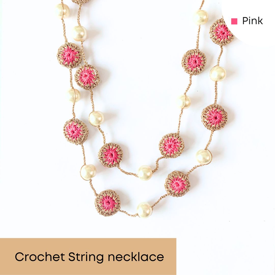 Pink crocheted necklace with delicate motifs and pearl beads