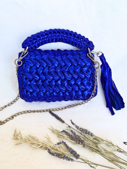 Electric blue crochet handbag with tassel and detachable chain.