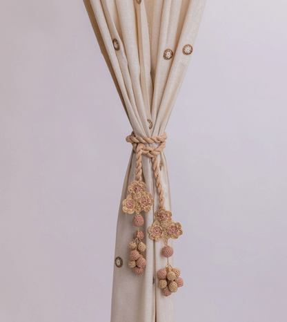 Subtle and elegant crocheted curtain tie backs adorned with delicate flowers and beads.