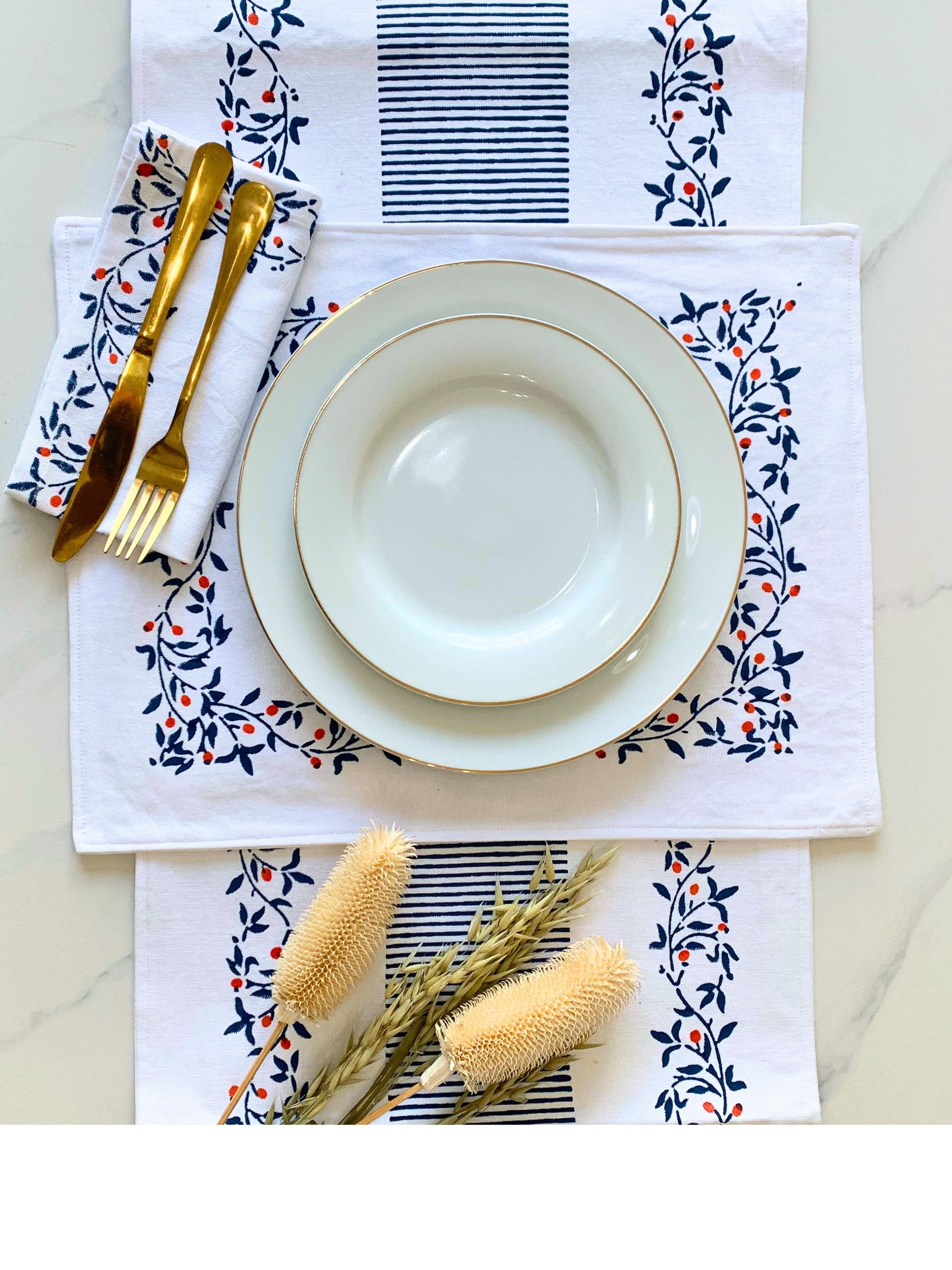 Sustainable sophistication at your table – a GOTS certified organic cotton table runner with a block-printed floral pattern and clean lines, available in two colors.