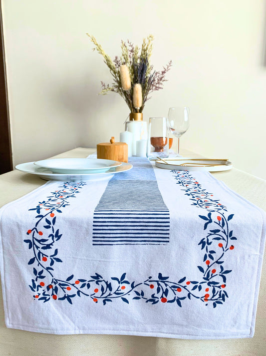 GOTS certified organic cotton table runner with a seamlessly paired block-printed floral pattern and clean lines, offering a perfect blend of quality and sustainability. Available in deep blue.