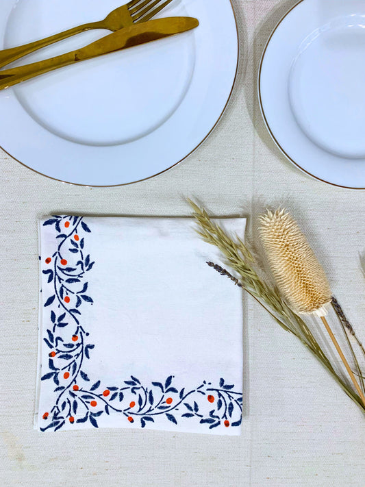 Blue Eco-friendly set of 6 napkins, block printed on GOTS certified organic cotton, showcasing a blue floral border for an elegant table setting.