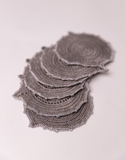 Charcoal grey and silver crochet coaster, a sophisticated addition to your tabletop.