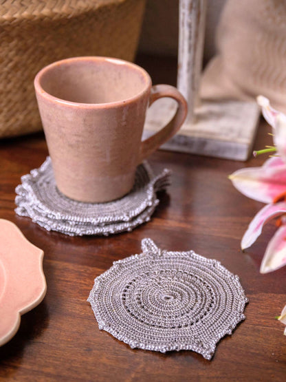 Charcoal grey and silver leaf-shaped crochet coaster, a stylish tabletop accent