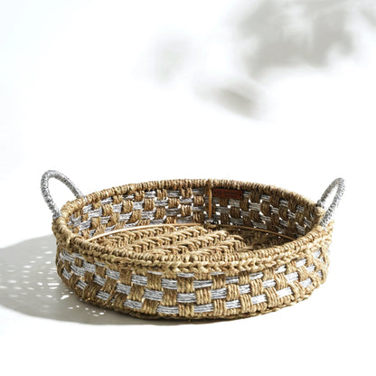 Elevate your breakfast table with this handwoven tray, blending natural grass and upcycled plastic for a touch of luxe. Woven in shades of natural and silver.