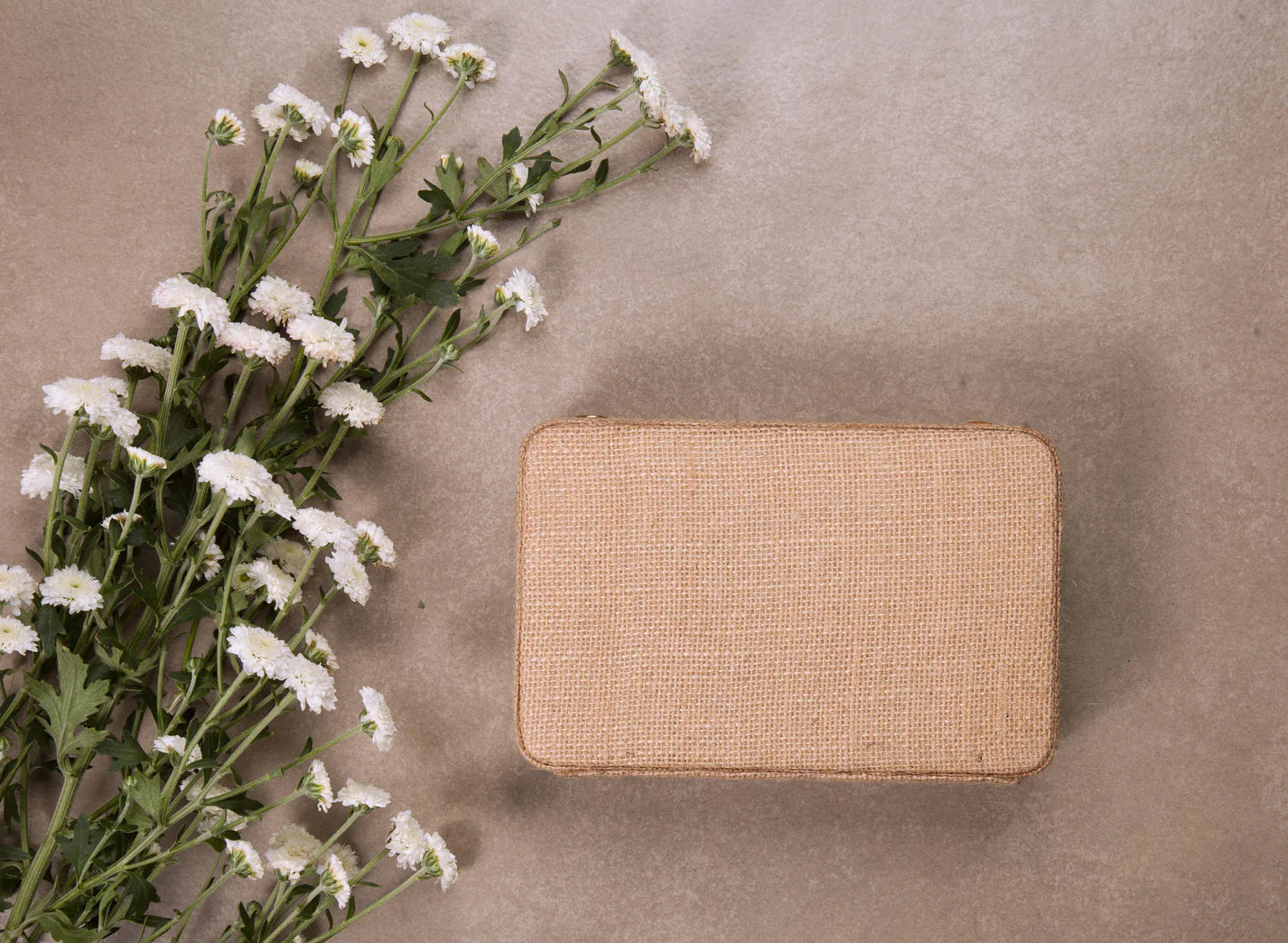 Hand-embroidered box clutch with attachable metal sling chain for versatile styling options.