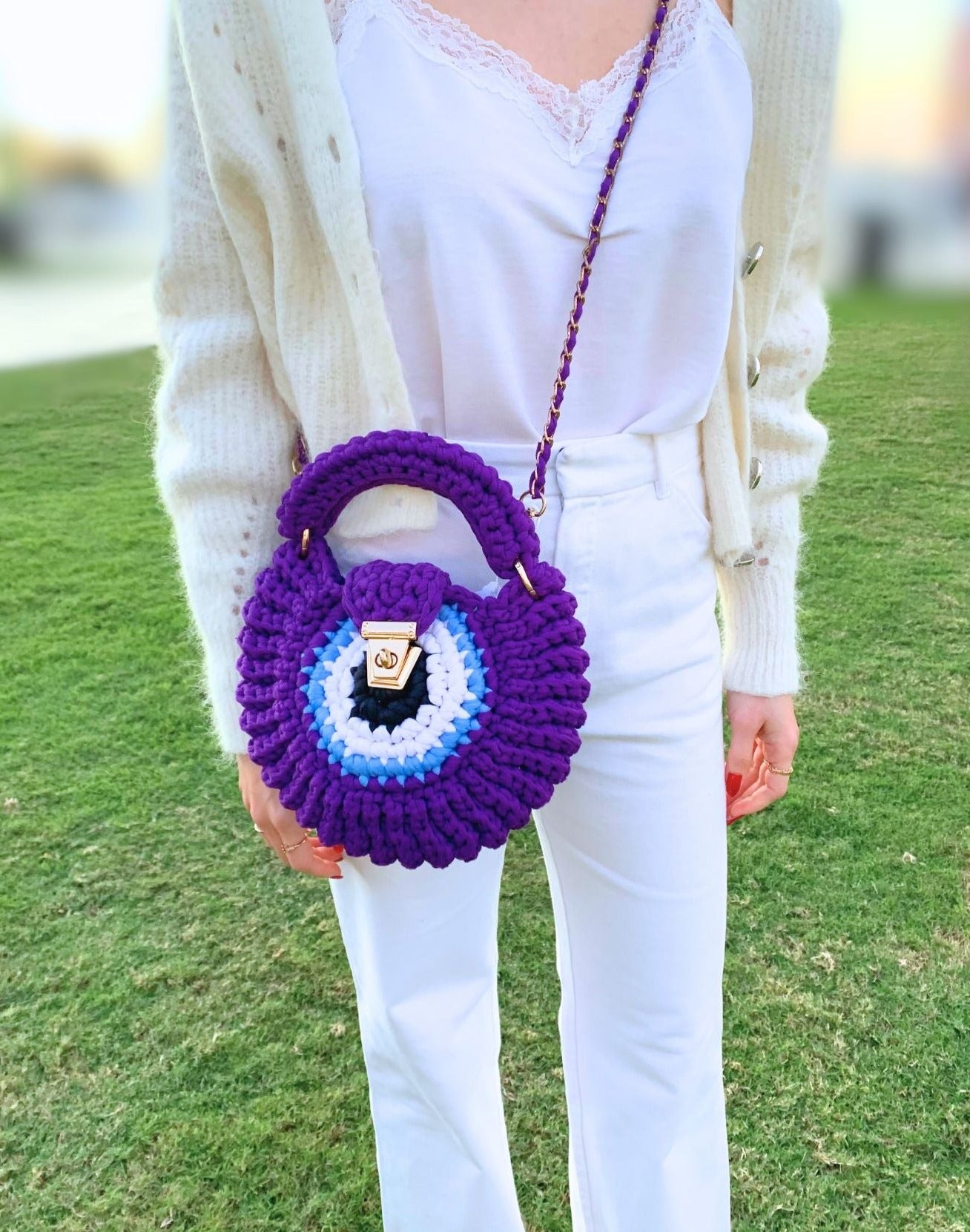 Elevate your style with a captivating handcrafted crochet bag featuring a vibrant evil eye design.