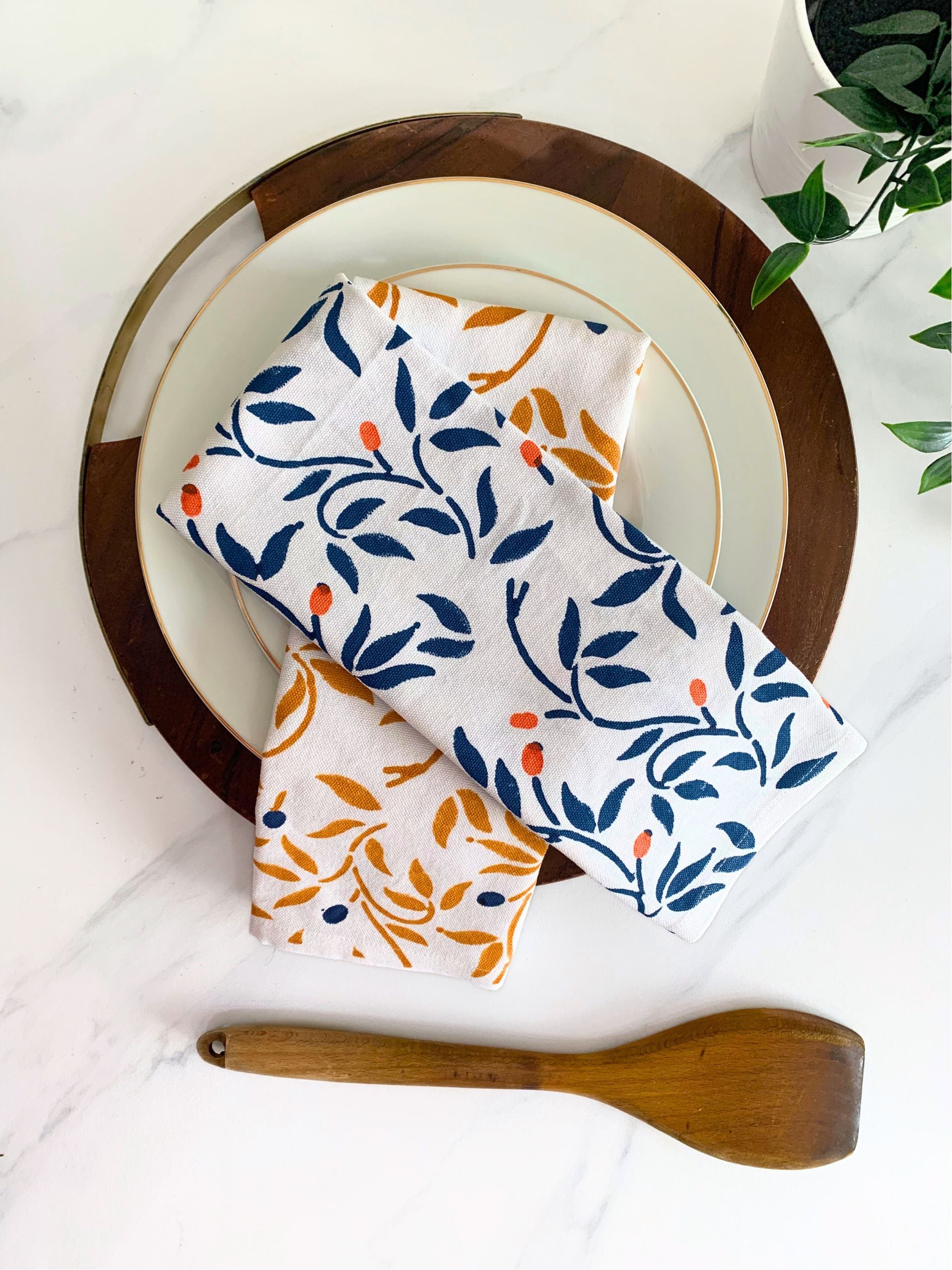 Set of 2 floral tea towels in blue and mustard, crafted from organic cotton for a sustainable kitchen experience.