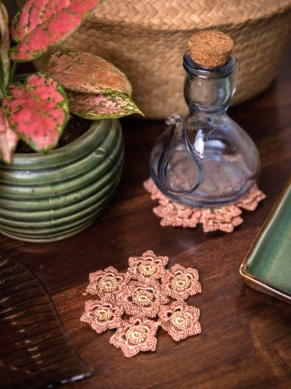 Rust beige floral crochet coaster, a delicate tabletop accessory.