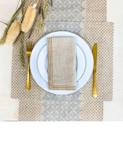 Crafted from GOTS certified organic cotton, this set of 6 placemats features an elegant geometric pattern with dull gold and silver accents, adding style and sustainability to your table setting.