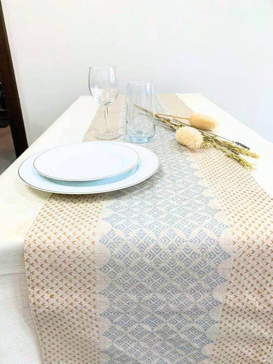 Sustainably chic GOTS certified organic cotton table runner featuring an elegant geometric pattern with block-printed dull gold and silver accents – the perfect addition for glamorous house parties.