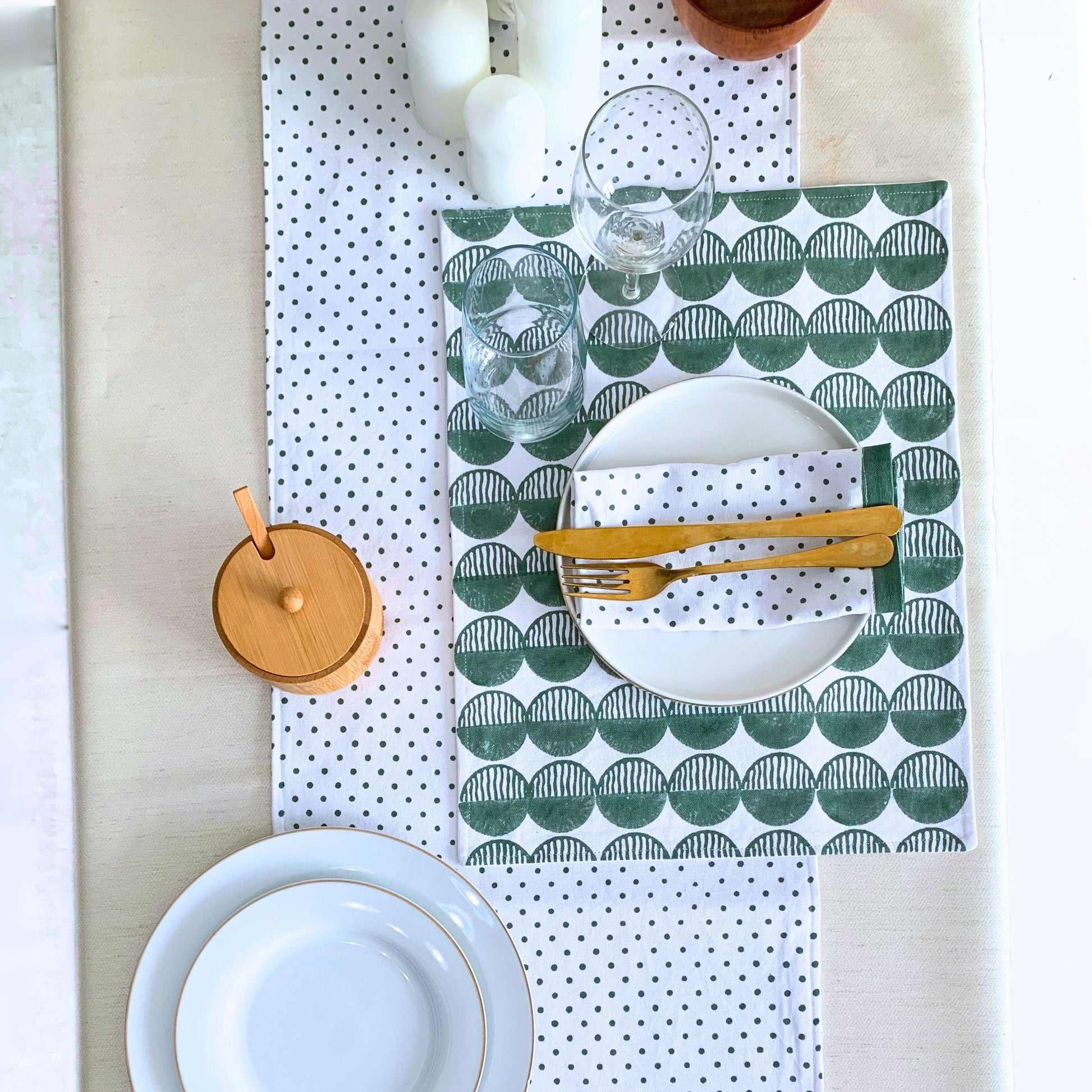 Block printed green placemats set with rhythmic circles.