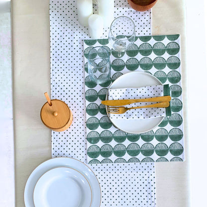 Block printed green placemats set with rhythmic circles.