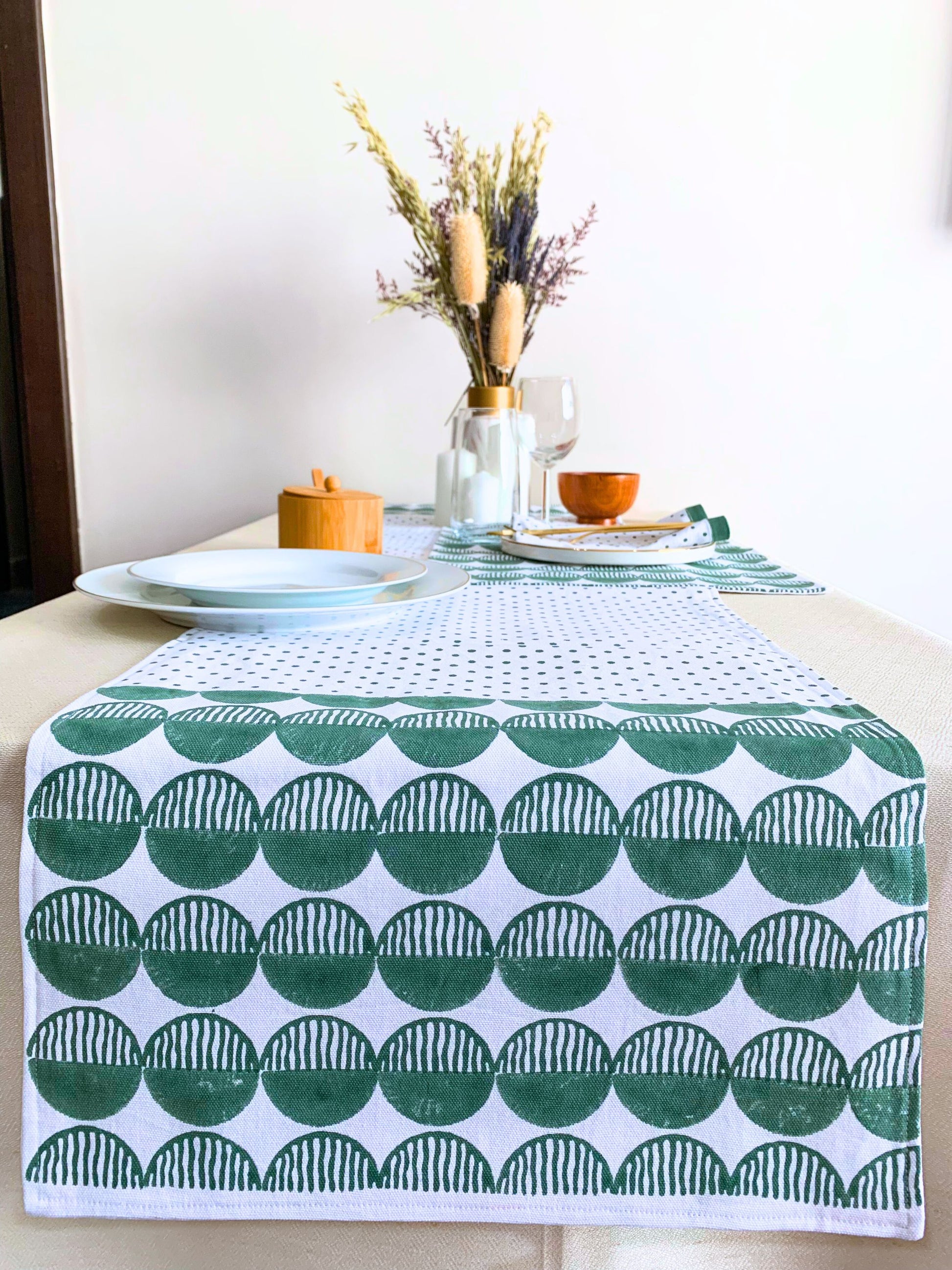 GOTS certified organic cotton table runner with block printed geometric pattern in green.