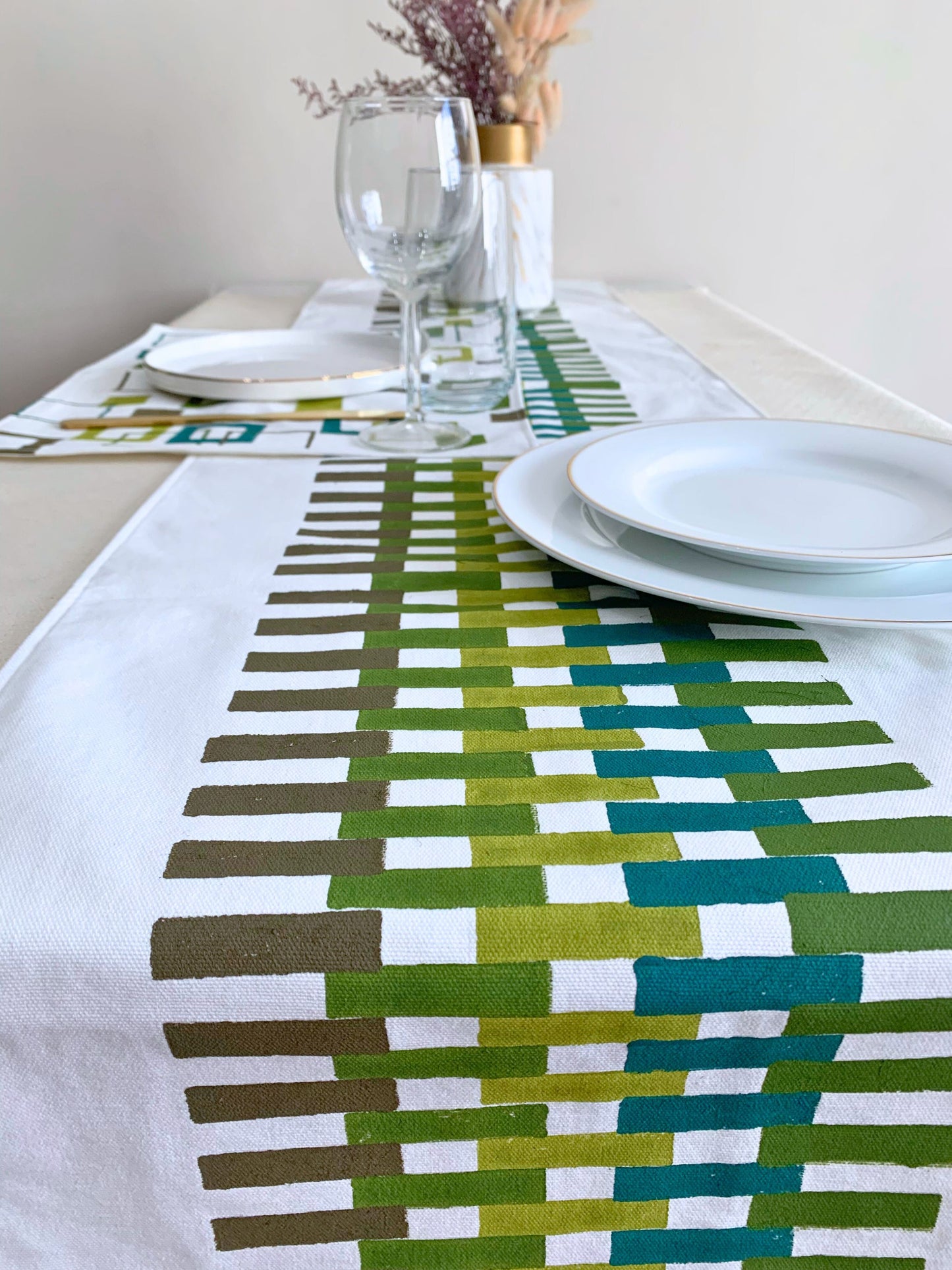 Block printed Geometric table runner in shades of green on organic cotton.