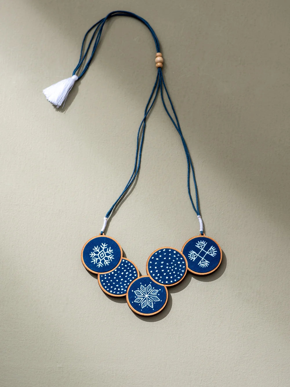 Sustainable fashion accessory adorned with hand-painted design on indigo fabric.