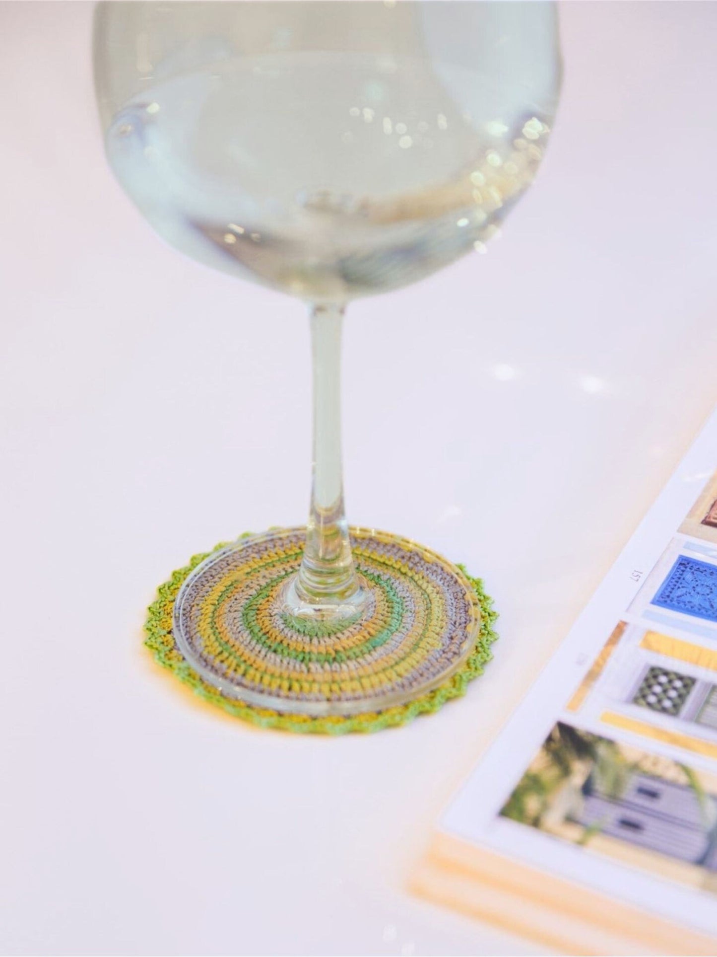 Protect surfaces in style with a lime green round crochet coaster.