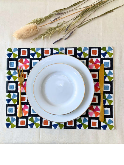 Add a pop of color to your table with block printed placemats, featuring an unconventional geometric pattern in a spectrum of colors. Crafted from GOTS certified organic cotton with a double-layered construction, these placemats offer durability, style, and sustainability.