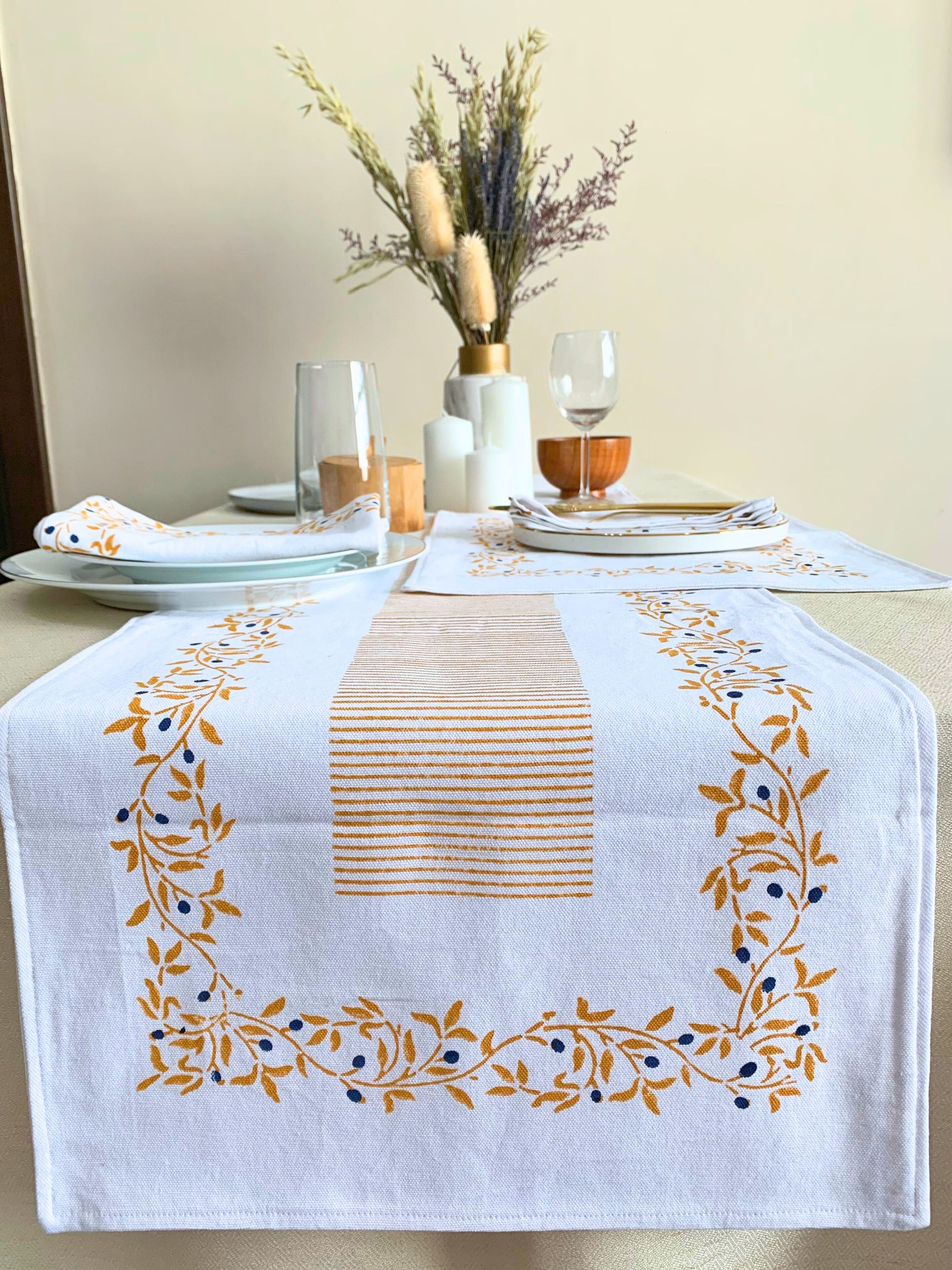 Complete your dining set with this GOTS certified organic cotton table runner, showcasing a block-printed floral pattern and clean lines, available in mustard colors.