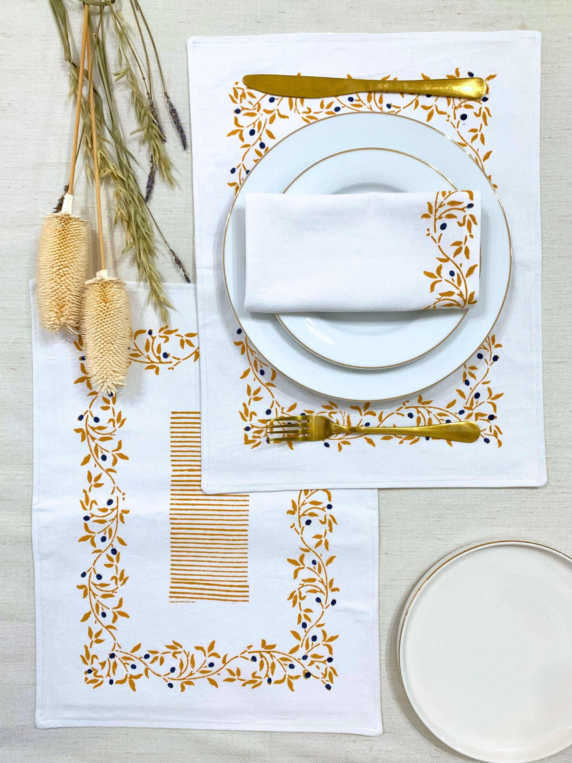 Sustainable dining made stylish – set of 6 double-layered placemats, block printed with a mustard floral pattern and sketchy lines on GOTS certified organic cotton.