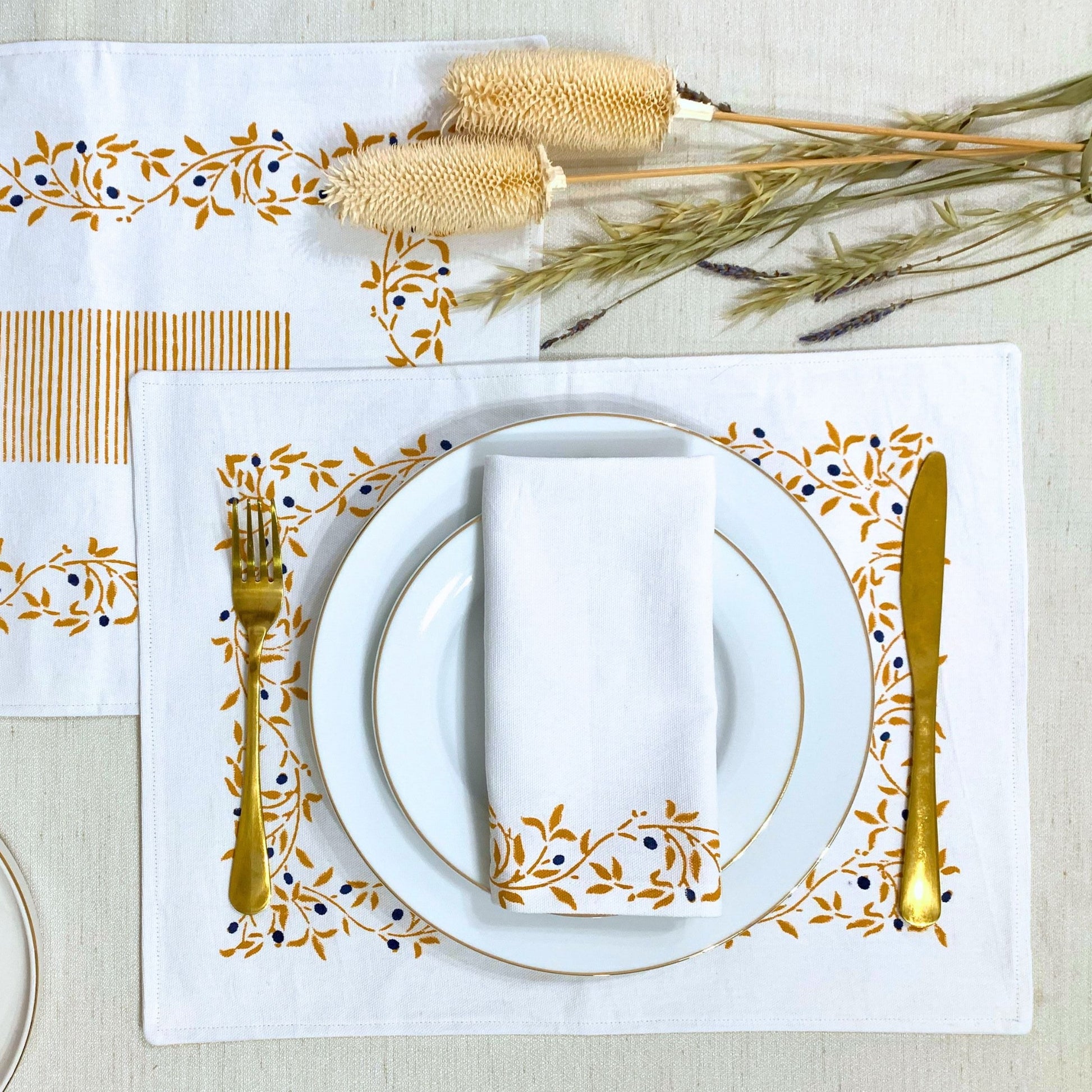 Complete your dining ensemble with this eco-conscious set of 6 napkins, crafted from GOTS certified organic cotton and featuring a mustard floral pattern