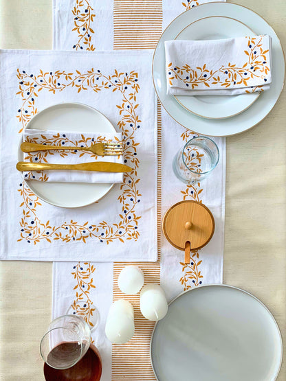 Add a touch of nature-inspired elegance to your table setting with this mustard color GOTS certified organic cotton table runner, featuring a block-printed floral pattern and clean lines.