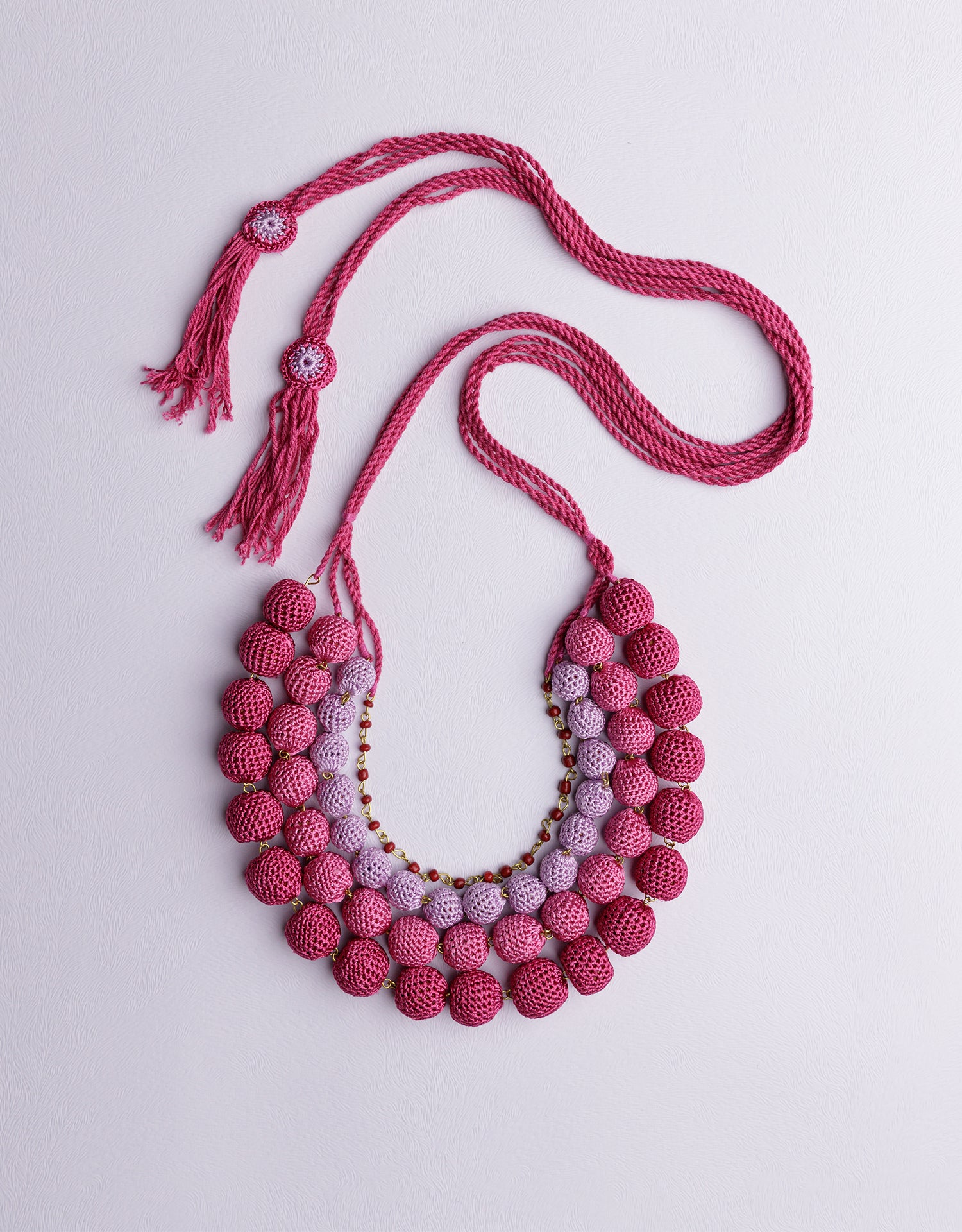 Eye-catching four-layered bead necklace in Pink, handcrafted to be your go-to statement piece.