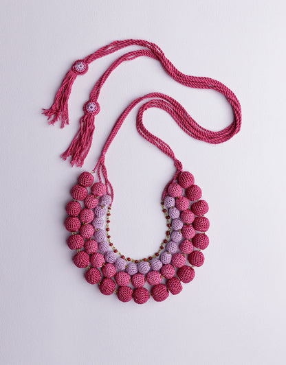 Eye-catching four-layered bead necklace in Pink, handcrafted to be your go-to statement piece.