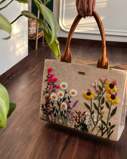 Experience elegance and sustainability with our Handcrafted Garden Tote Bag, featuring a stunning hand-embroidered floral design on natural-colored sustainable fabric.