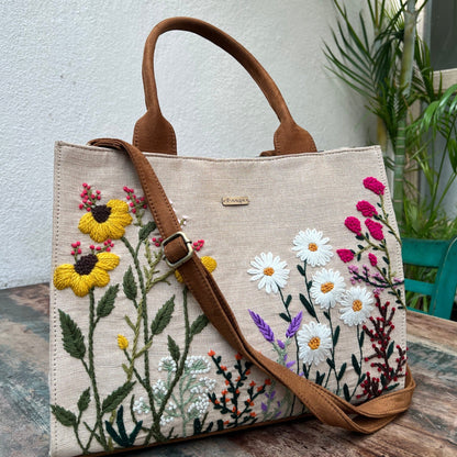 This unique tote includes a soft Vegan suede touch, premium threads, a secure zipper closure, and functional interior pockets.