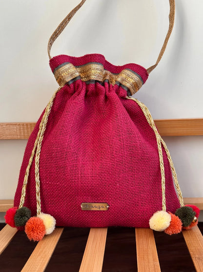 Floral Potli bag with detailed embroidery and metal sequin embellishments, ideal for ethnic and festive occasions.