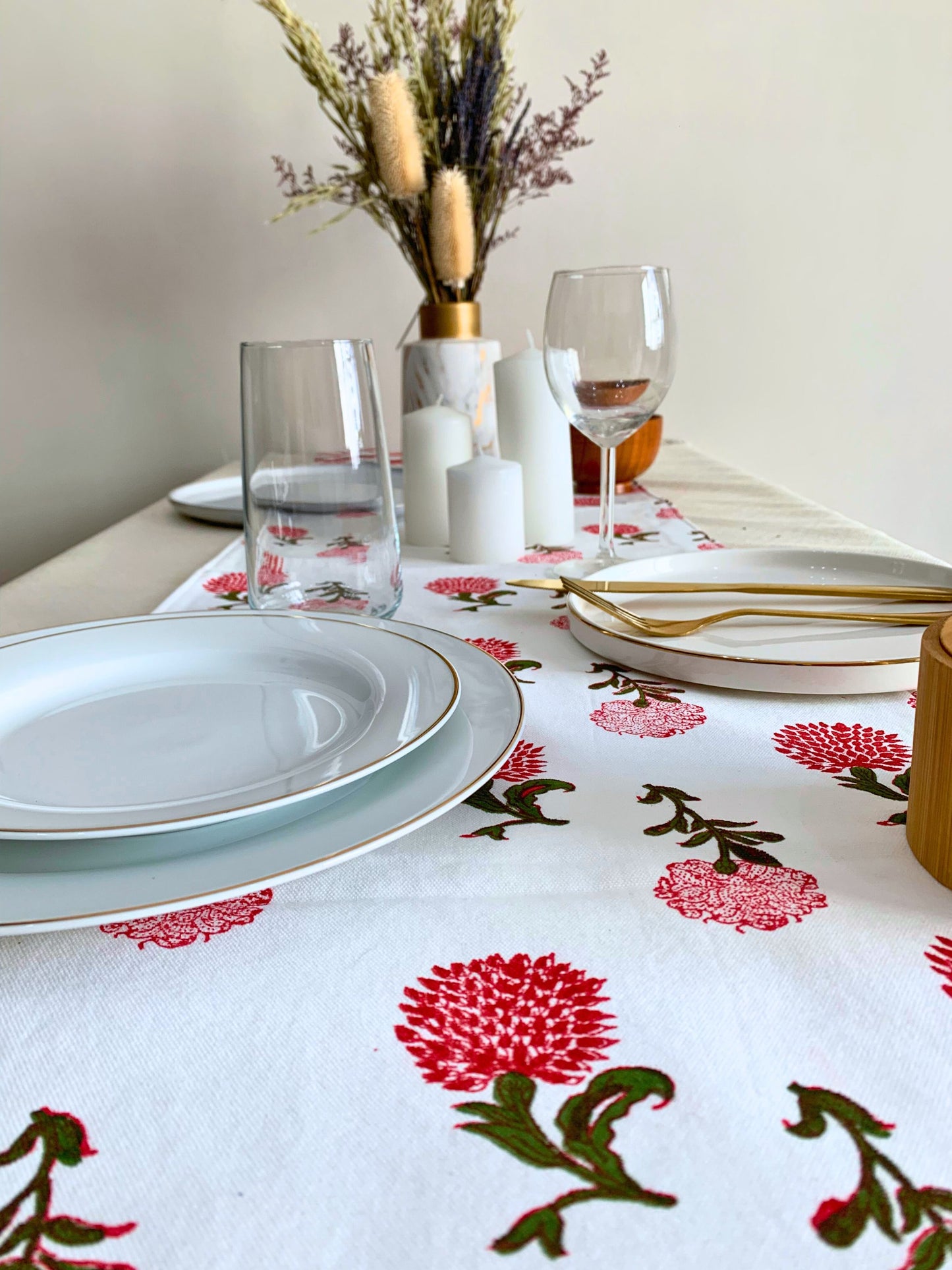 Enhance your table setting with a double-layered white table runner, crafted from GOTS certified organic cotton, showcasing vibrant red and green block printed motifs.