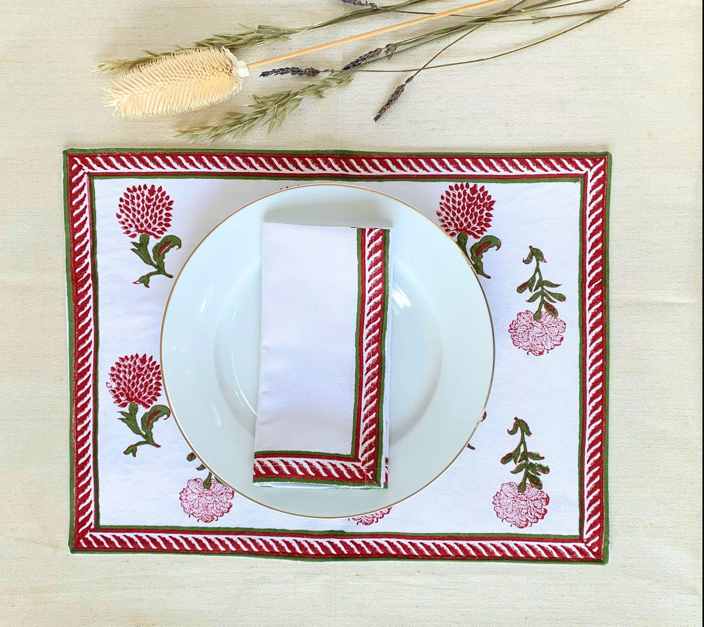 Upgrade your dining experience with this set of 6 napkins, showcasing a vibrant red and green block printed border on GOTS certified organic cotton for both elegance and sustainability.