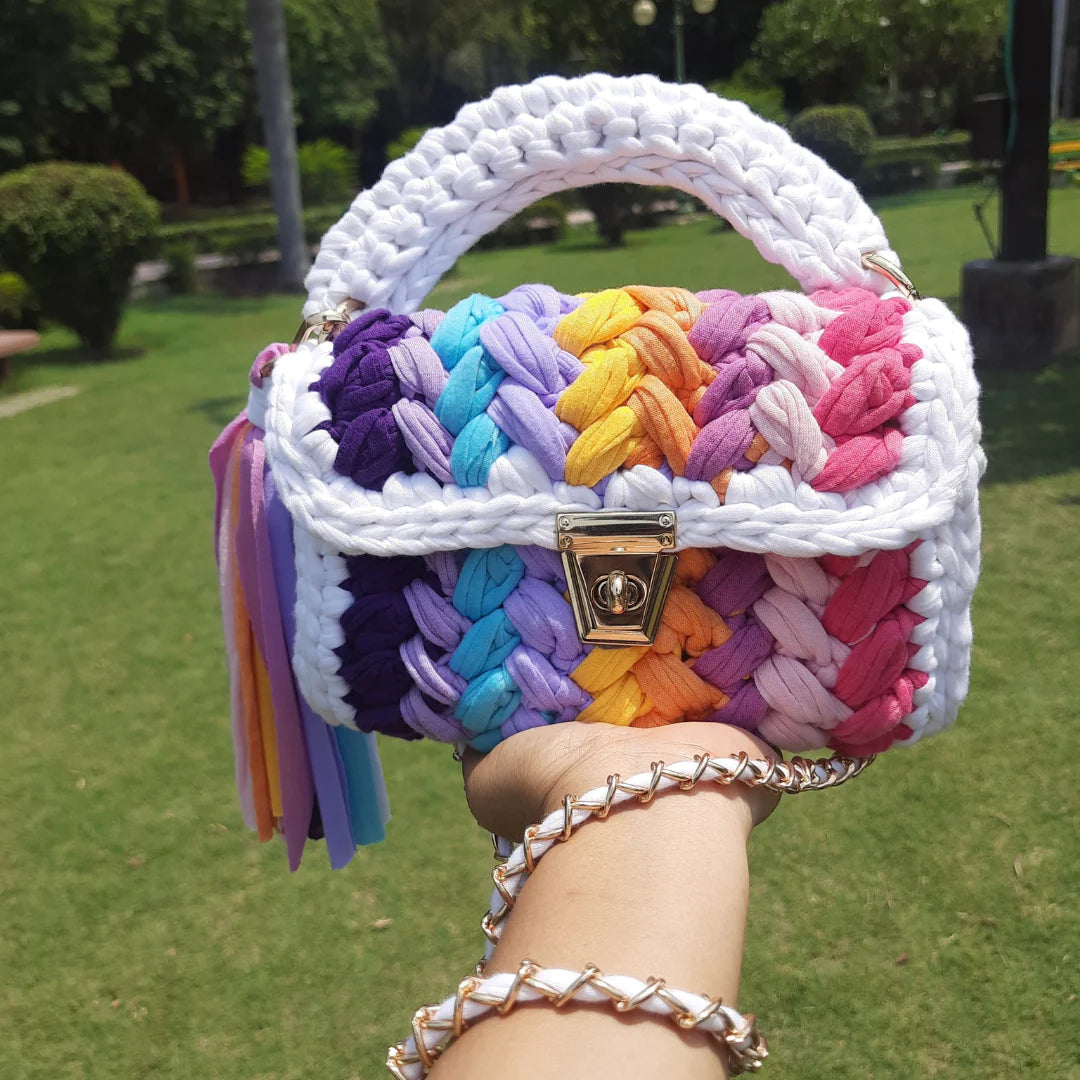 Rainbow crochet handbag with a white border.