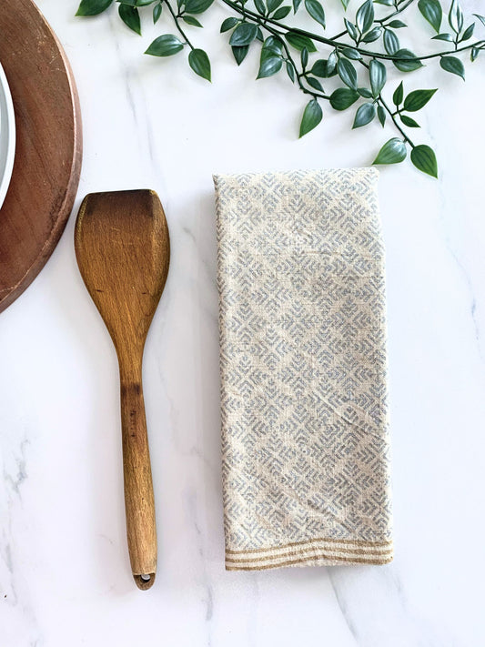 Upgrade your kitchen essentials with this set of 2 identical tea towels, crafted from organic cotton, showcasing an elegant geometric pattern with block-printed dull gold and silver accents on natural-beige fabric.