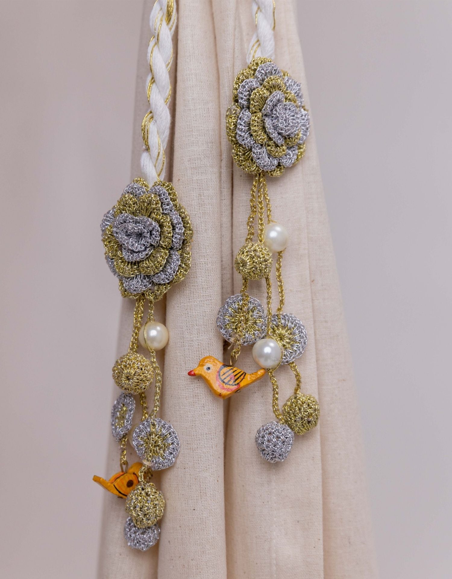 Secure your curtains in style with these charming crochet tie backs in gold and silver.