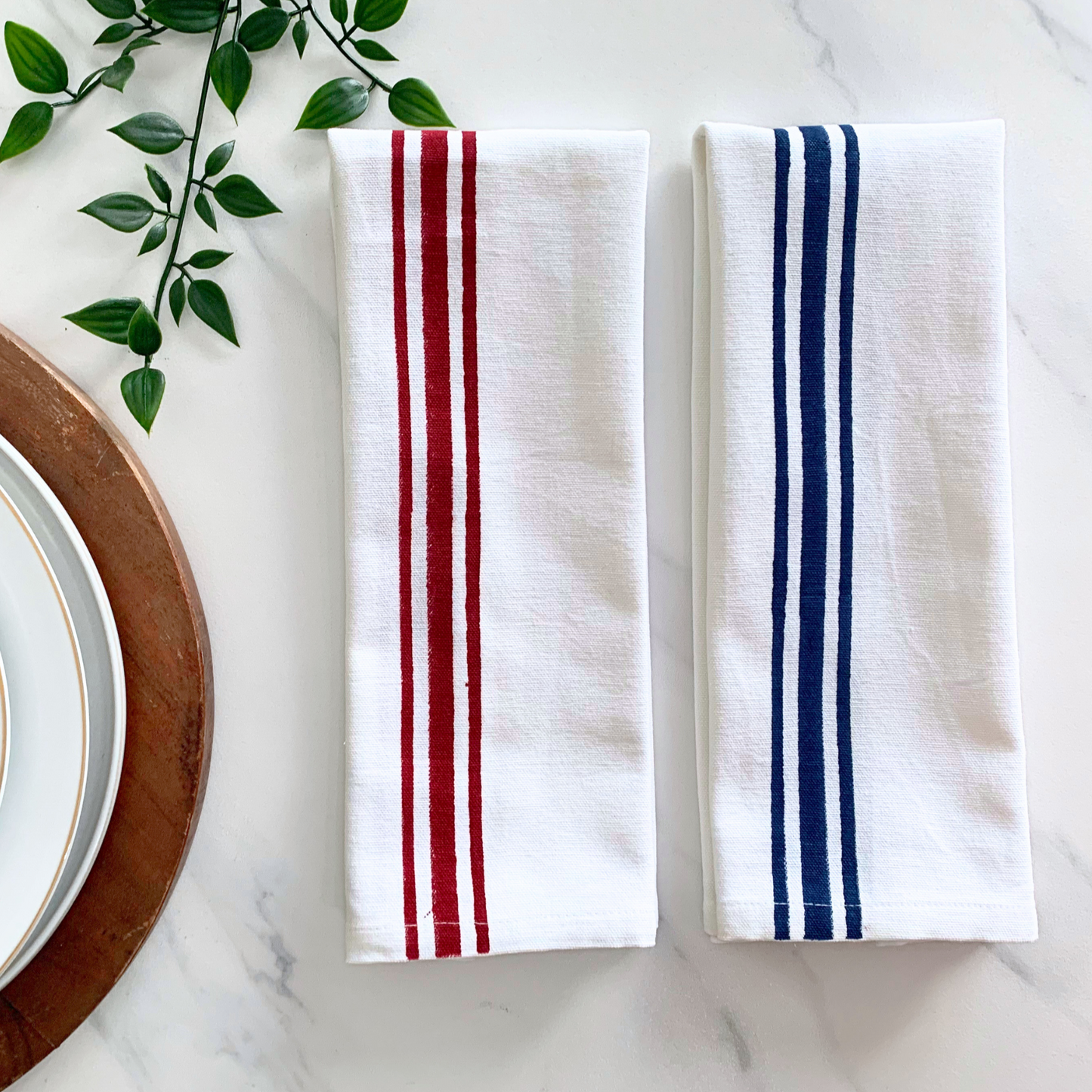 Sustainable kitchen chic – tea towels with maroon and blue block printed line borders, crafted from GOTS certified organic cotton for an eco-conscious kitchen.