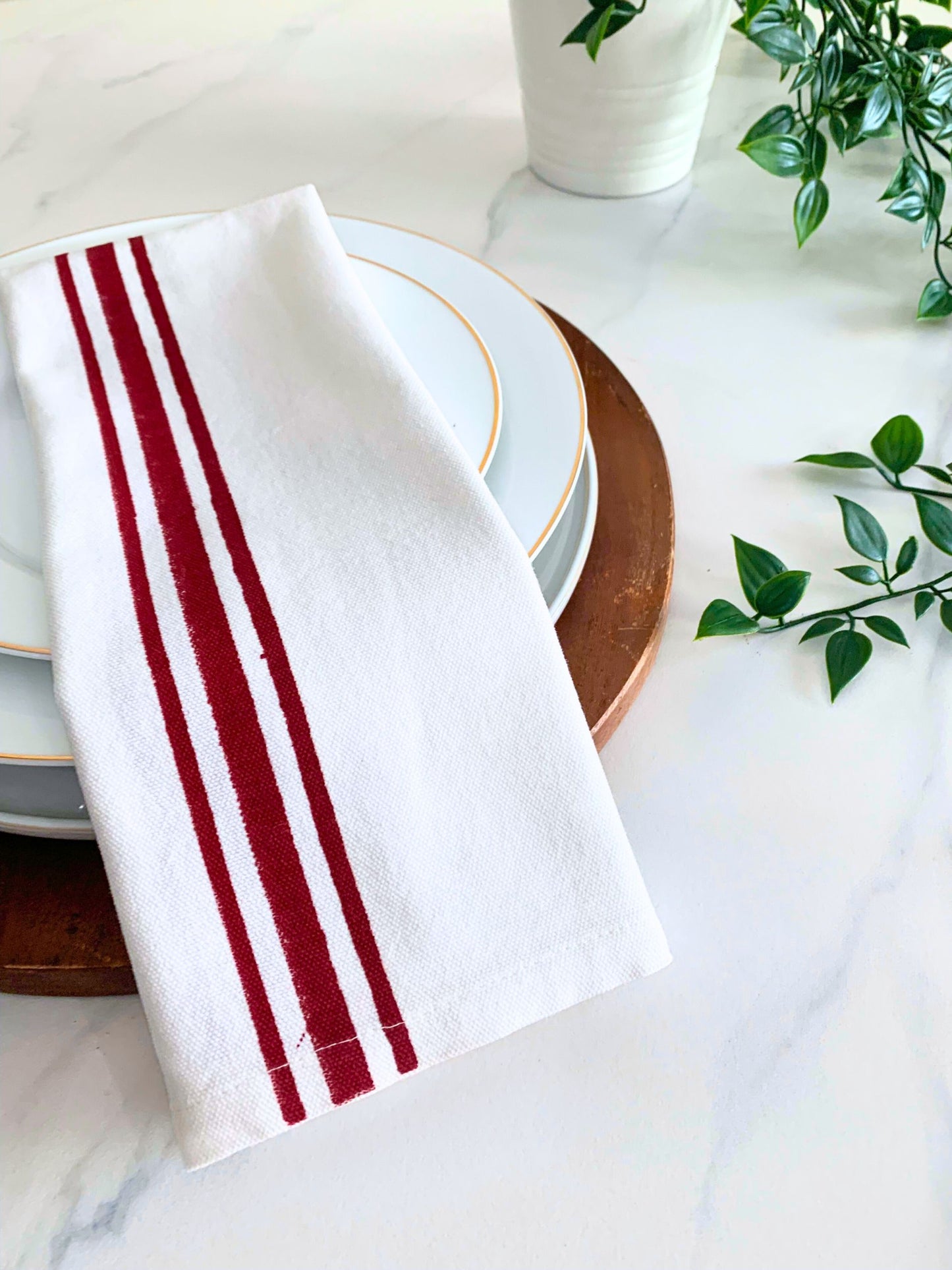 Enhance your kitchen decor with these GOTS certified organic cotton tea towels, showcasing maroon and blue block printed line borders for both style and sustainability.