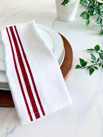 Enhance your kitchen decor with these GOTS certified organic cotton tea towels, showcasing maroon and blue block printed line borders for both style and sustainability.