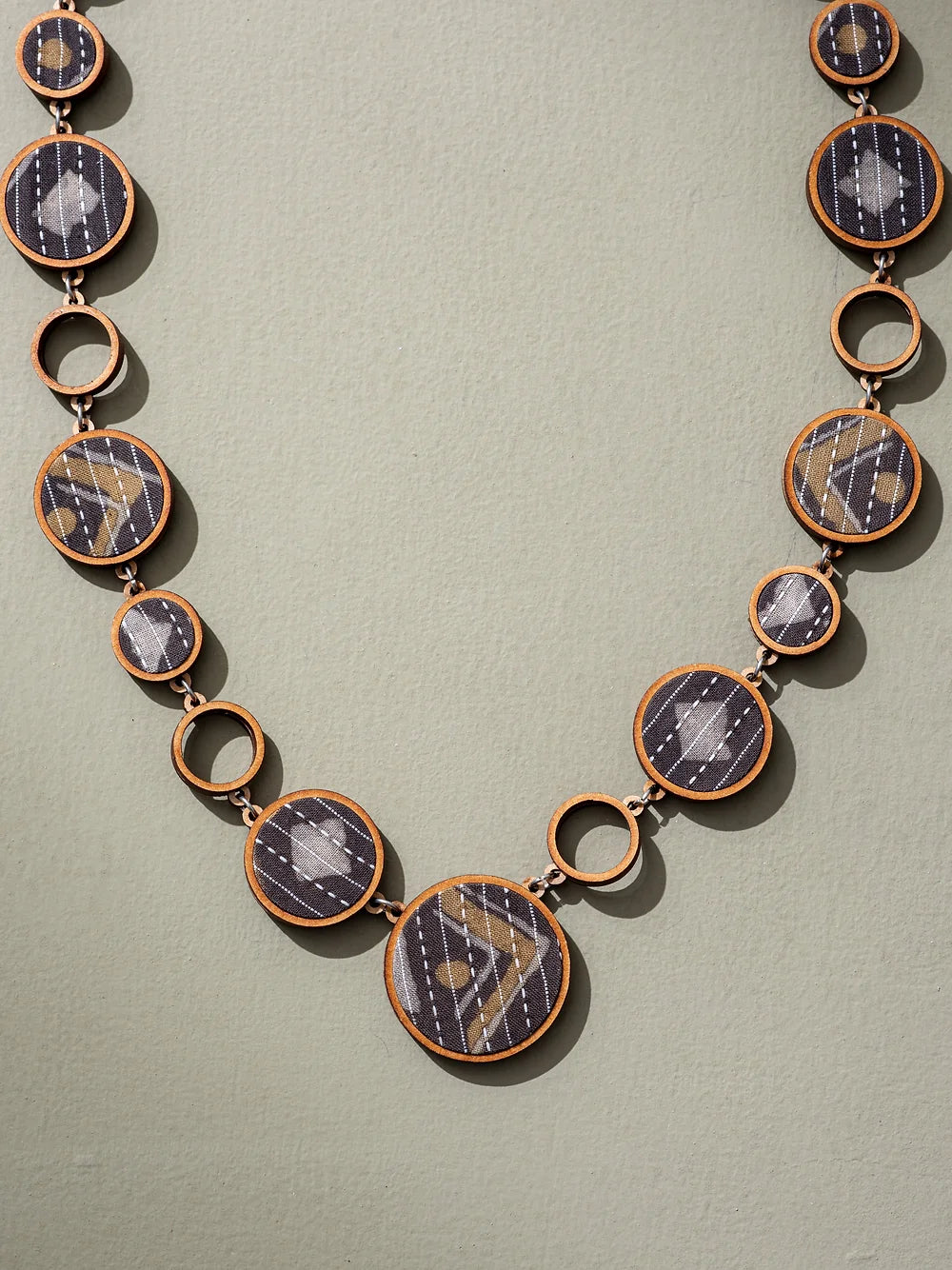 Chic and sustainable necklace with reversible design, made from upcycled materials.