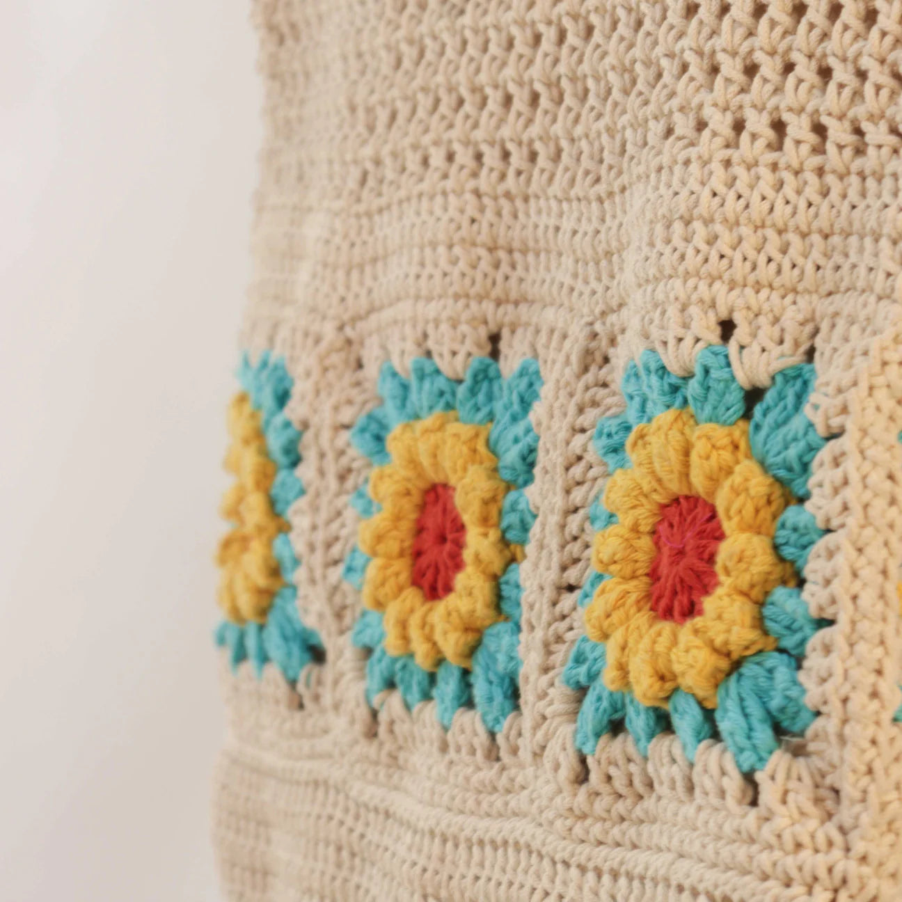 hand-crocheted tote bag, meticulously designed for both style and practicality. The charming floral motifs in Off White, Red, Blue, and Yellow add an elegant touch to your everyday essentials.