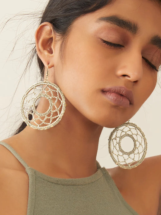 Golden crochet earring with captivating mandala pattern, adding intricate beauty to any ensemble.