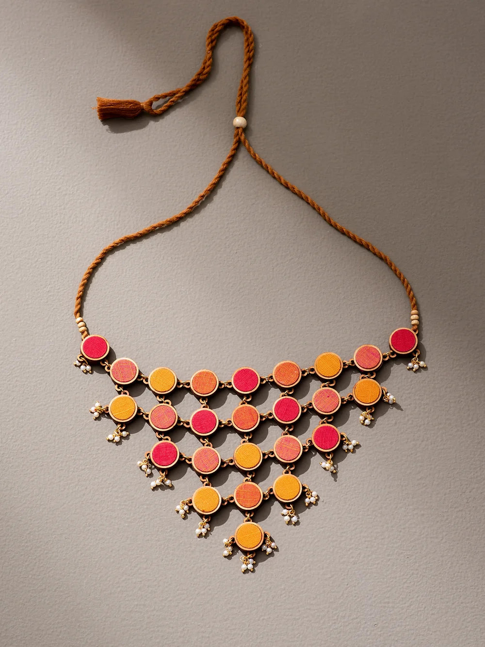 Eco-friendly statement necklace crafted with recycled fabric waste, perfect for sustainable style.