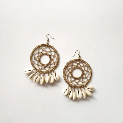 Fashionable crochet earrings with mesmerizing bronze hue and delicate white shell embellishments.