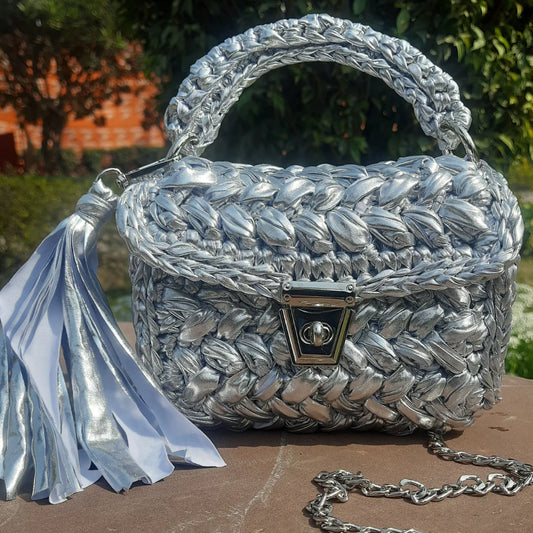 handcrafted crochet party bag in silver, perfect for parties.