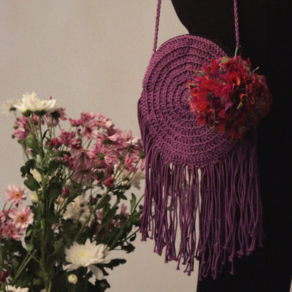 round cotton bag, hand-crocheted with 100% cotton yarn, playful tassels, and recycled textile waste bobbles