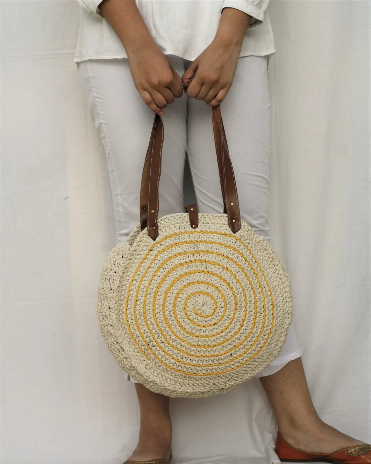 Elevate your accessories with this direct-from-craftsman everyday tote, hand-crocheted from high-quality cotton yarn.